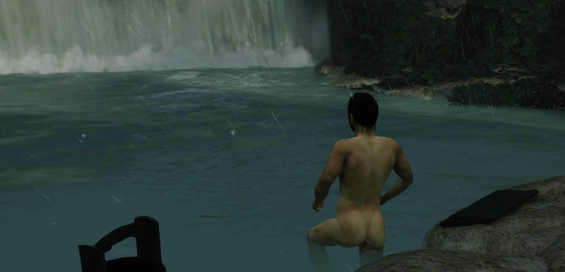 jin's bare ass as he descends into a pool of water near a waterfall